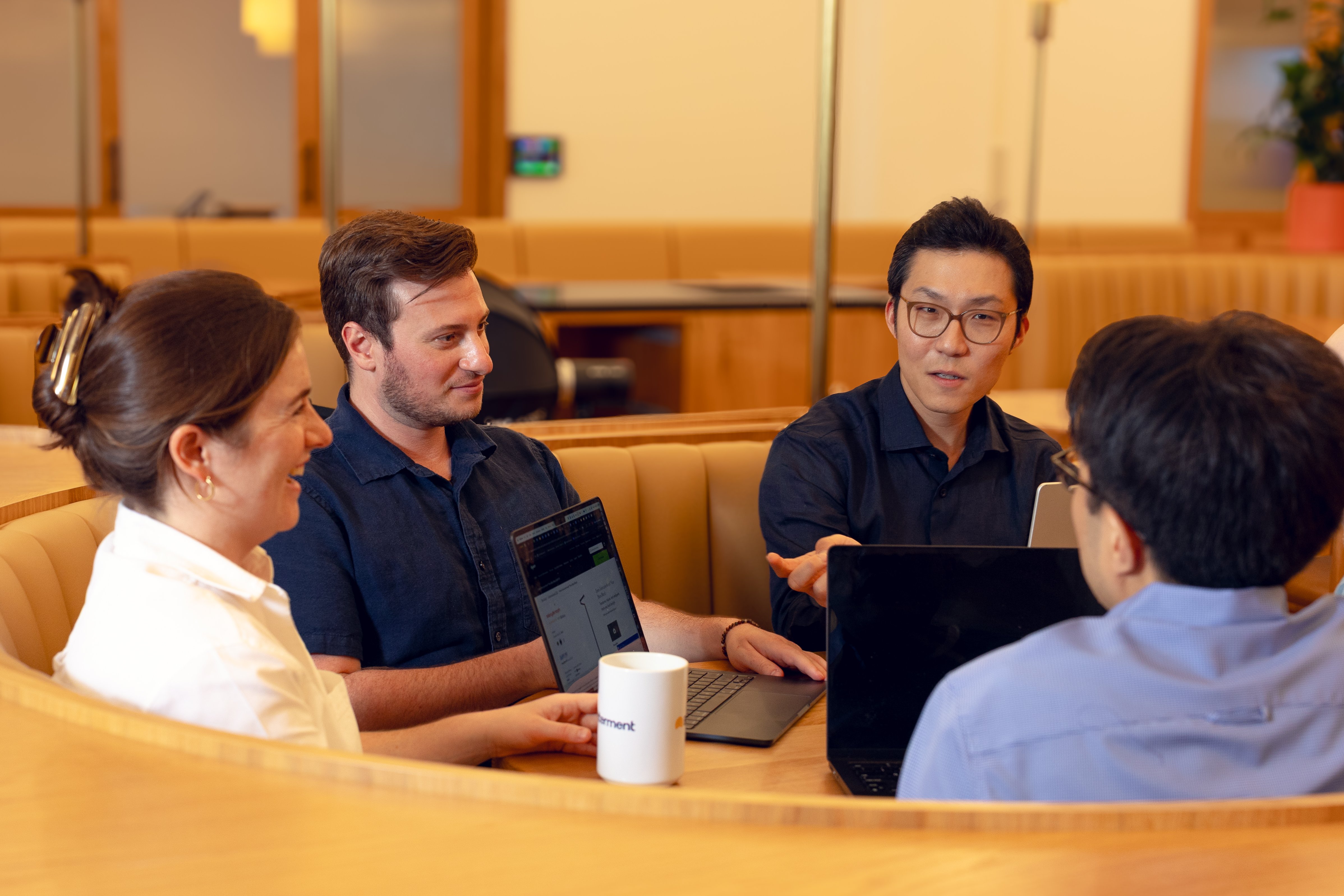 A photograph of members of the Betterment Investing team meeting.